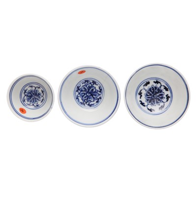 Lot 443 - Three Chinese blue and white 'lotus' cups, Qing dynasty, 18th/19th century