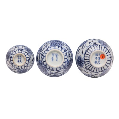 Lot 443 - Three Chinese blue and white 'lotus' cups, Qing dynasty, 18th/19th century