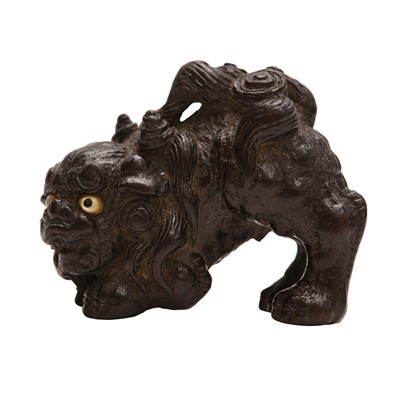 Lot 54 - A fine Japanese ebony netsuke of a shishi, Meiji period