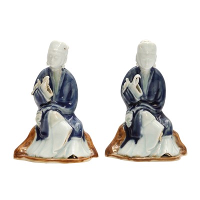 Lot 193 - A pair of Chinese glazed biscuit 'lady' figures, Qing dynasty, Qianlong period