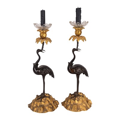Lot 45 - A pair of bronze and parcel gilt candlesticks in the manner of Thomas Abbott