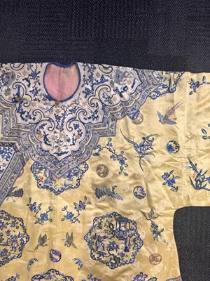 Lot 395 - A fine Chinese yellow-ground embroidered silk robe, Qing dynasty, 19th Century