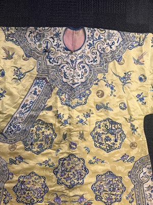 Lot 395 - A fine Chinese yellow-ground embroidered silk robe, Qing dynasty, 19th Century