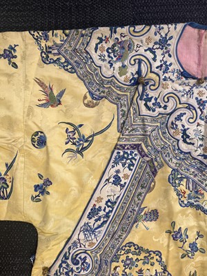 Lot 395 - A fine Chinese yellow-ground embroidered silk robe, Qing dynasty, 19th Century