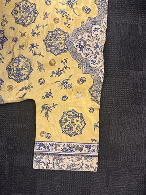 Lot 395 - A fine Chinese yellow-ground embroidered silk robe, Qing dynasty, 19th Century