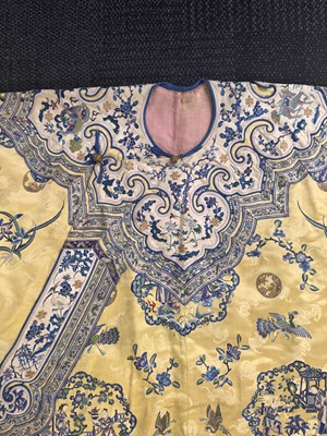 Lot 395 - A fine Chinese yellow-ground embroidered silk robe, Qing dynasty, 19th Century