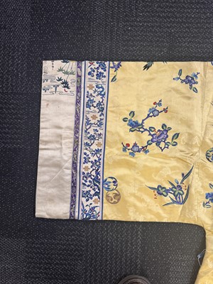 Lot 395 - A fine Chinese yellow-ground embroidered silk robe, Qing dynasty, 19th Century