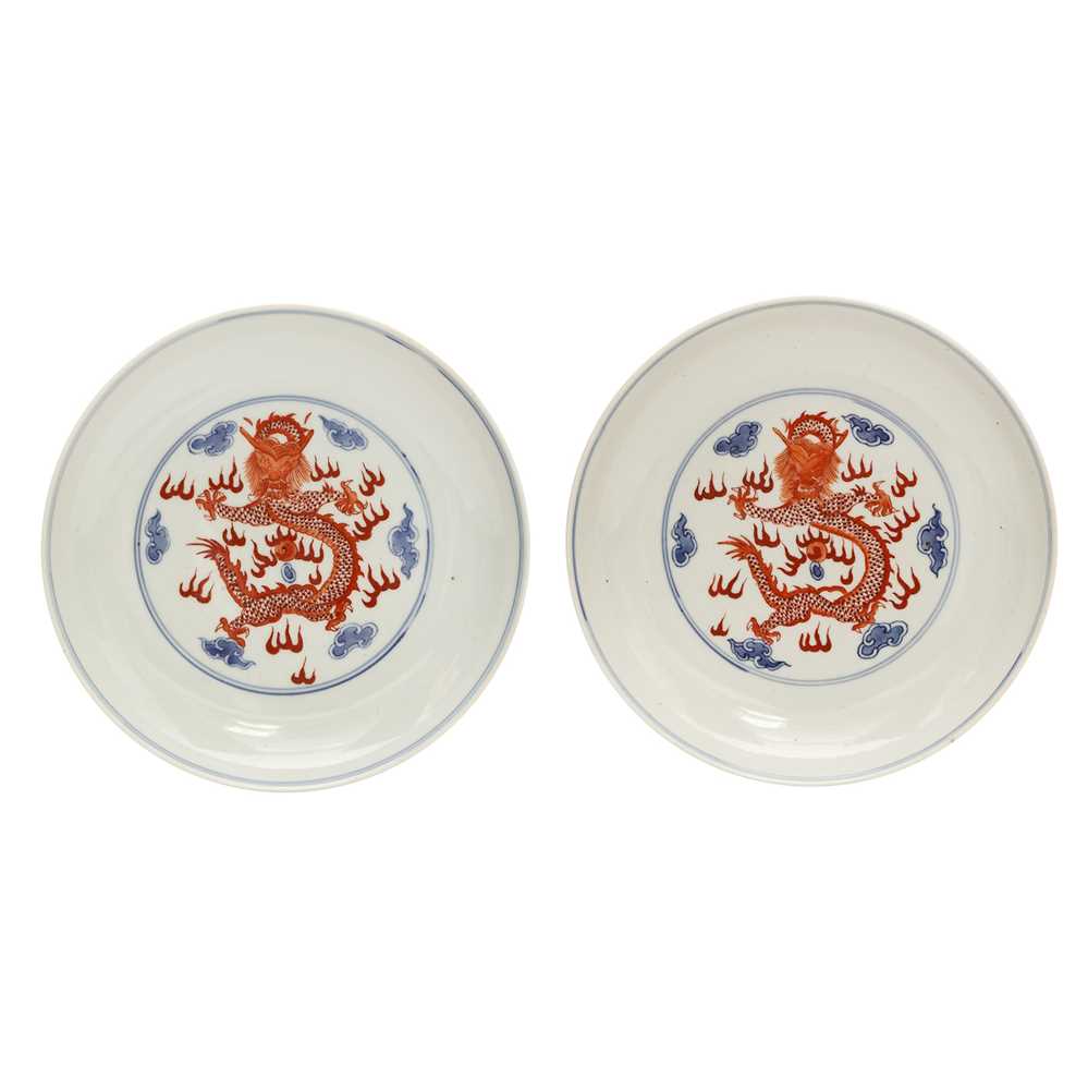 Lot 487 - A pair of Chinese blue and white and iron-red 'dragon' dishes, 19th - 20th century