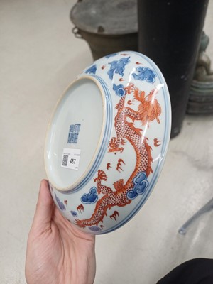Lot 487 - A pair of Chinese blue and white and iron-red 'dragon' dishes, 19th - 20th century