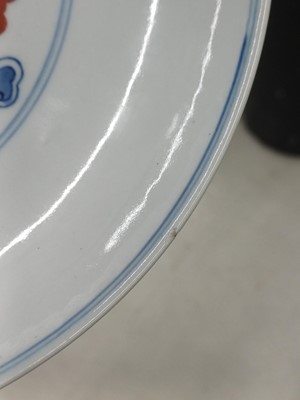 Lot 487 - A pair of Chinese blue and white and iron-red 'dragon' dishes, 19th - 20th century