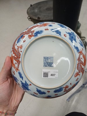 Lot 487 - A pair of Chinese blue and white and iron-red 'dragon' dishes, 19th - 20th century