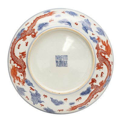 Lot 487 - A pair of Chinese blue and white and iron-red 'dragon' dishes, 19th - 20th century