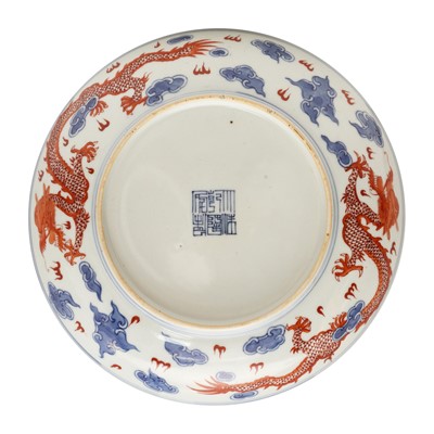Lot 487 - A pair of Chinese blue and white and iron-red 'dragon' dishes, 19th - 20th century
