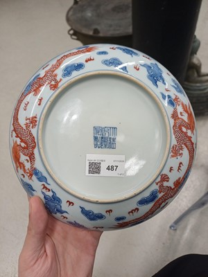 Lot 487 - A pair of Chinese blue and white and iron-red 'dragon' dishes, 19th - 20th century