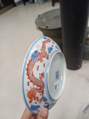 Lot 487 - A pair of Chinese blue and white and iron-red 'dragon' dishes, 19th - 20th century