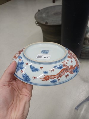 Lot 487 - A pair of Chinese blue and white and iron-red 'dragon' dishes, 19th - 20th century