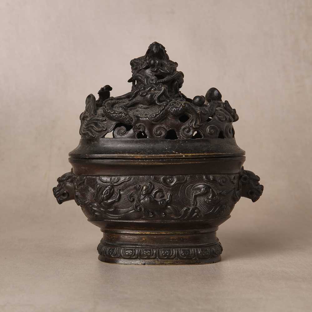 Lot 74 - A fine Chinese bronze parcel-gilt 'dragon and phoenix' censer and cover, 17th century
