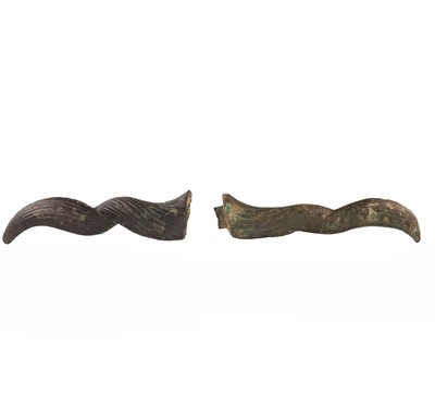 Lot 77 - A pair of Egyptian bronze ram’s horns from an atef crown, Late Period – Ptolemaic