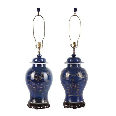 Lot 275 - A near-pair of Chinese gilt-decorated powder-blue vases and covers, Qing dynasty, 18th century