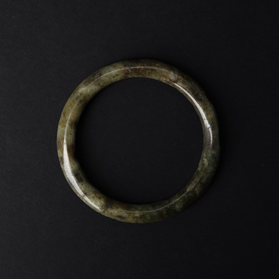 Lot 583 - A Chinese green jade bangle
