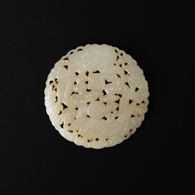 Lot 148 - A Chinese white jade 'dragon' round plaque, 18th/19th century