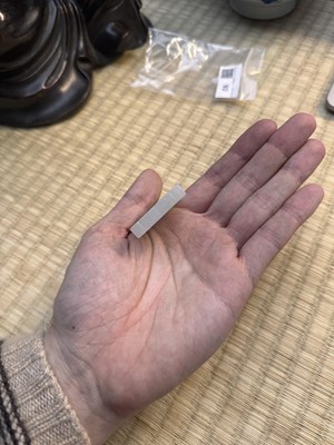 Lot 92 - A Chinese white jade 'figurative' pendant plaque, Qing dynasty, 18th/19th century