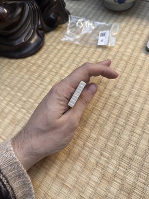 Lot 92 - A Chinese white jade 'figurative' pendant plaque, Qing dynasty, 18th/19th century