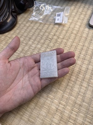 Lot 92 - A Chinese white jade 'figurative' pendant plaque, Qing dynasty, 18th/19th century