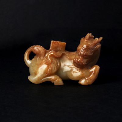 Lot 140 - A Chinese russet jade 'Qilin' group, 19th/20th century