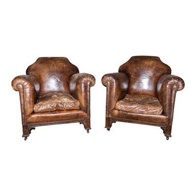 Lot 114 - A pair of Edwardian tobacco brown leather tub armchairs