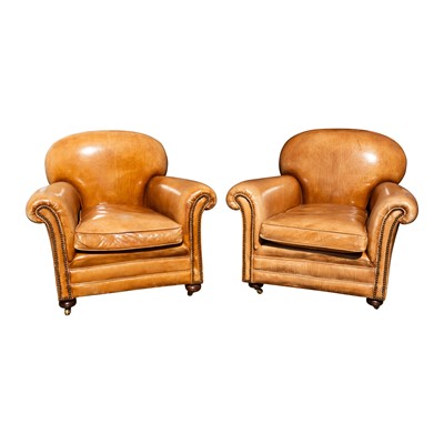 Lot 113 - A pair of early to mid 20th Century tan leather club armchairs