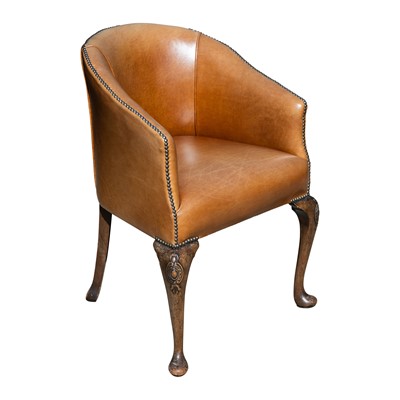 Lot 110 - An early 20th century tan leather upholstered tub chair