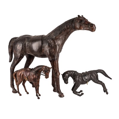 Lot 147 - In the manner of Liberty & Co. of London, three leather horses