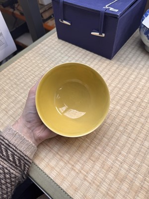 Lot 62 - A Chinese green-enamelled yellow-ground 'dragon' bowl, Qianlong mark and possibly of the period