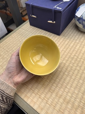 Lot 62 - A Chinese green-enamelled yellow-ground 'dragon' bowl, Qianlong mark and possibly of the period