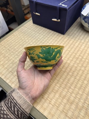 Lot 62 - A Chinese green-enamelled yellow-ground 'dragon' bowl, Qianlong mark and possibly of the period