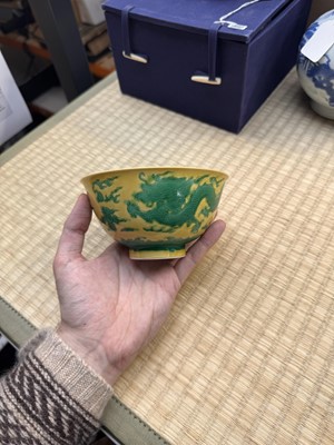 Lot 62 - A Chinese green-enamelled yellow-ground 'dragon' bowl, Qianlong mark and possibly of the period
