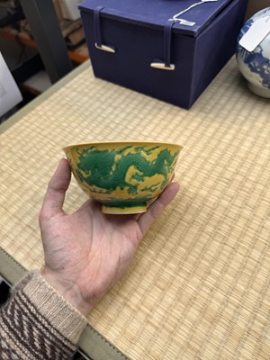 Lot 62 - A Chinese green-enamelled yellow-ground 'dragon' bowl, Qianlong mark and possibly of the period