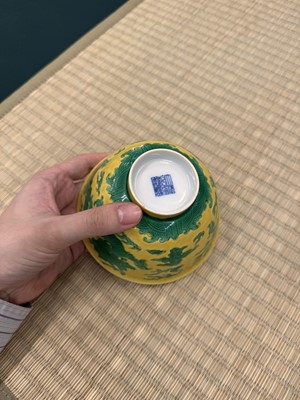 Lot 62 - A Chinese green-enamelled yellow-ground 'dragon' bowl, Qianlong mark and possibly of the period