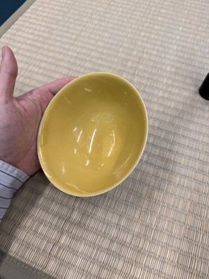 Lot 62 - A Chinese green-enamelled yellow-ground 'dragon' bowl, Qianlong mark and possibly of the period