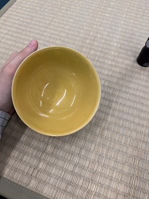 Lot 62 - A Chinese green-enamelled yellow-ground 'dragon' bowl, Qianlong mark and possibly of the period