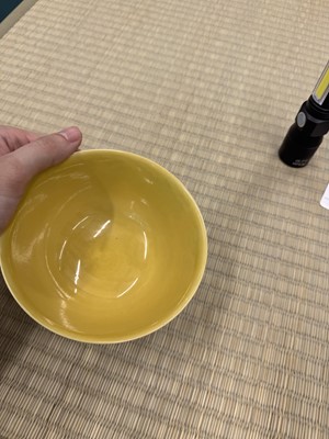 Lot 62 - A Chinese green-enamelled yellow-ground 'dragon' bowl, Qianlong mark and possibly of the period