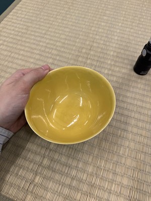 Lot 62 - A Chinese green-enamelled yellow-ground 'dragon' bowl, Qianlong mark and possibly of the period