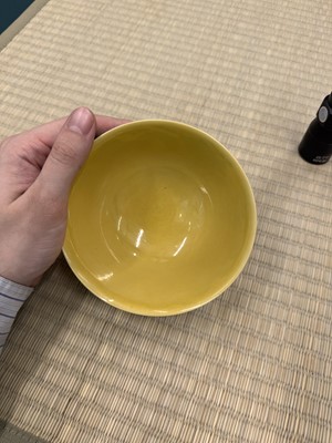 Lot 62 - A Chinese green-enamelled yellow-ground 'dragon' bowl, Qianlong mark and possibly of the period