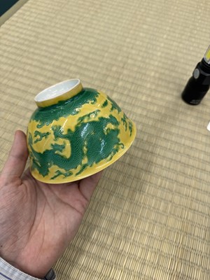 Lot 62 - A Chinese green-enamelled yellow-ground 'dragon' bowl, Qianlong mark and possibly of the period