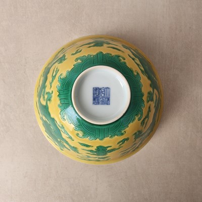 Lot 62 - A Chinese green-enamelled yellow-ground 'dragon' bowl, Qianlong mark and possibly of the period