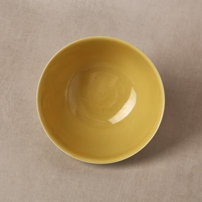 Lot 62 - A Chinese green-enamelled yellow-ground 'dragon' bowl, Qianlong mark and possibly of the period