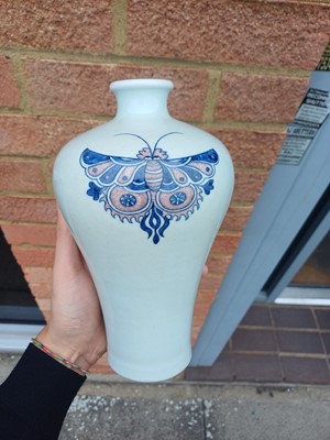 Lot 83 - A Chinese blue and white and copper-red 'butterfly' vase, 19th / 20th century
