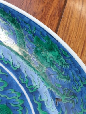 Lot 342 - A Chinese green-enamelled 'dragon' dish, late Qing dynasty, Kangxi mark