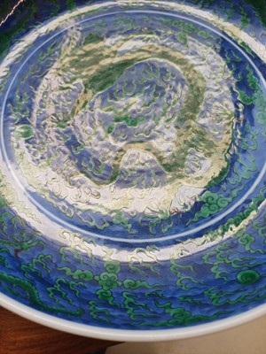 Lot 342 - A Chinese green-enamelled 'dragon' dish, late Qing dynasty, Kangxi mark